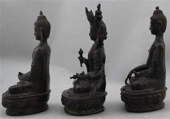 Three A Sino-Tibetan bronze seated figures of Buddhist deities, 20-21cm high